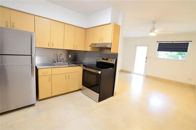 a kitchen with a sink a stove and a refrigerator