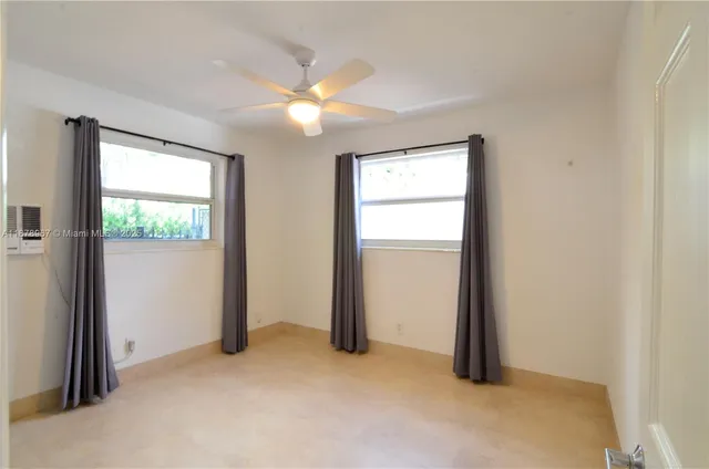 an empty room with closet and a window