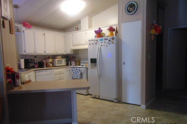3835 Gardiner Ferry Road, Unit 36 Corning, CA 96021 - Photo 14 of 43 a kitchen with refrigerator and cabinets