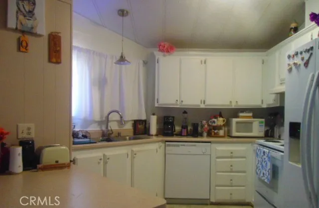 a bedroom with a bed and a flat tv screen on dresser