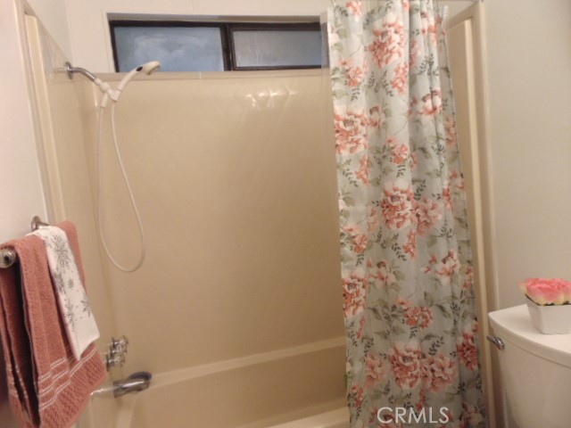 3835 Gardiner Ferry Road, Unit 36 Corning, CA 96021 - Photo 17 of 43 a bathroom with a shower curtain and a toilet