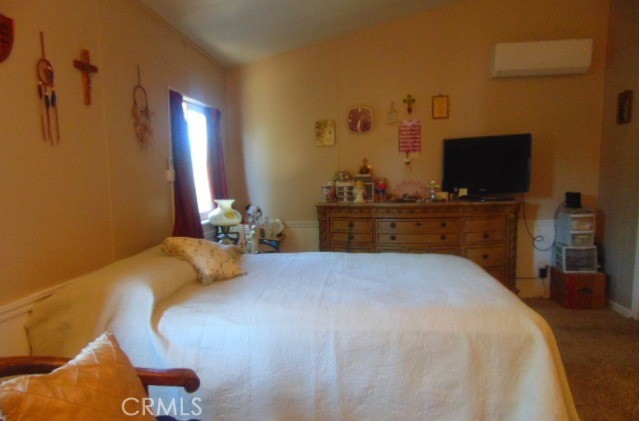 3835 Gardiner Ferry Road, Unit 36 Corning, CA 96021 - Photo 19 of 43 a bedroom with a bed and a flat screen tv