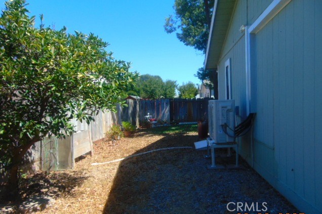 3835 Gardiner Ferry Road, Unit 36 Corning, CA 96021 - Photo 33 of 43 a view of a backyard with wooden fence and a large tree