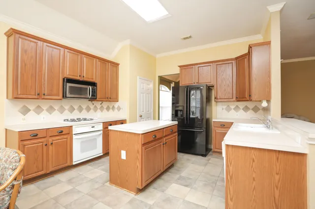 a kitchen with a sink stove and refrigerator