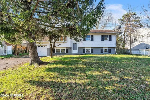 a view of house with a yard