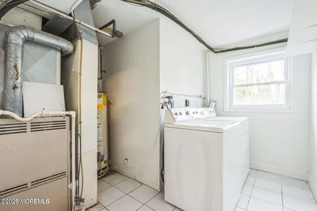 a utility room with closet dryer and washer