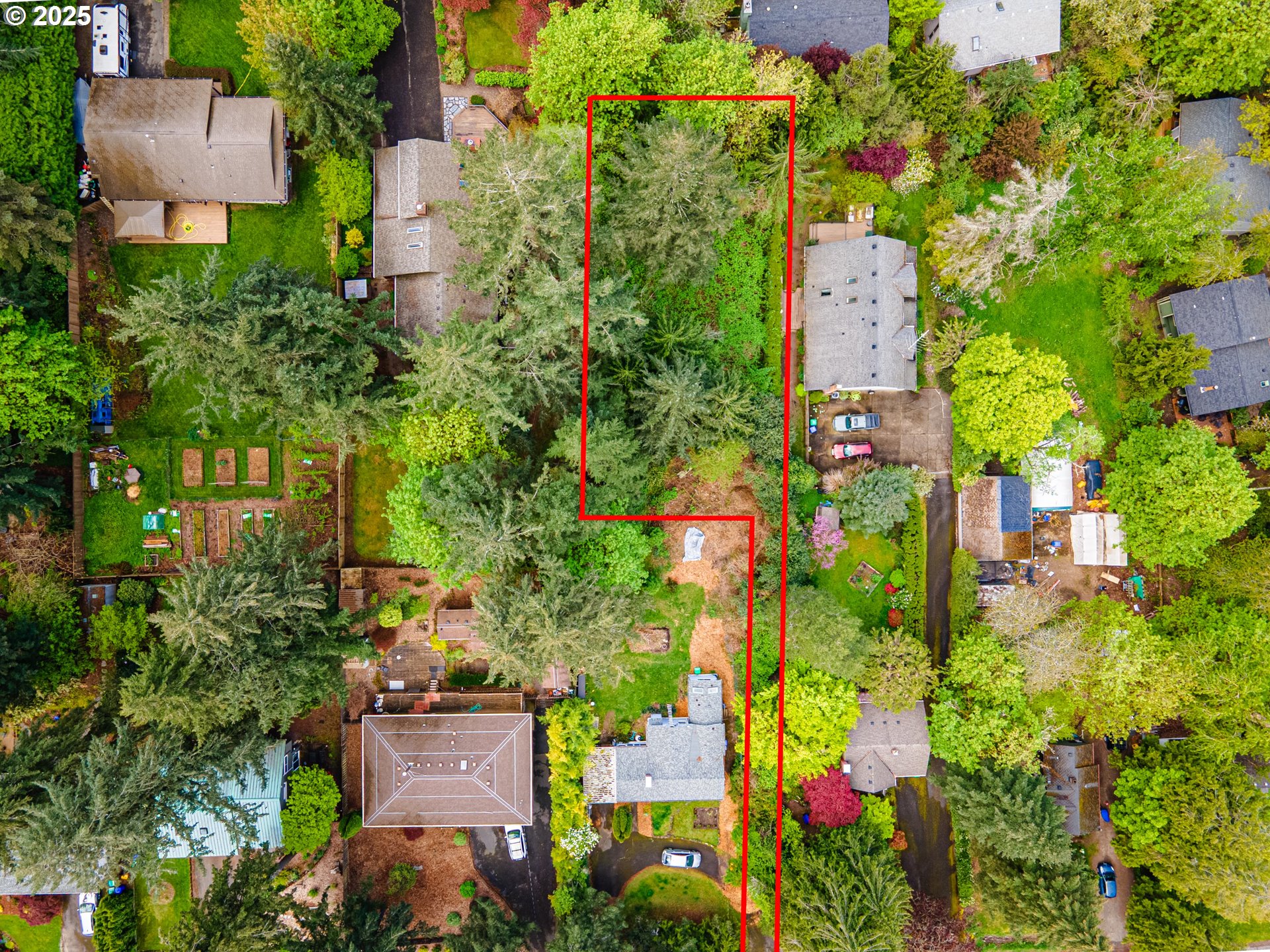 an aerial view of a house with a yard and garden