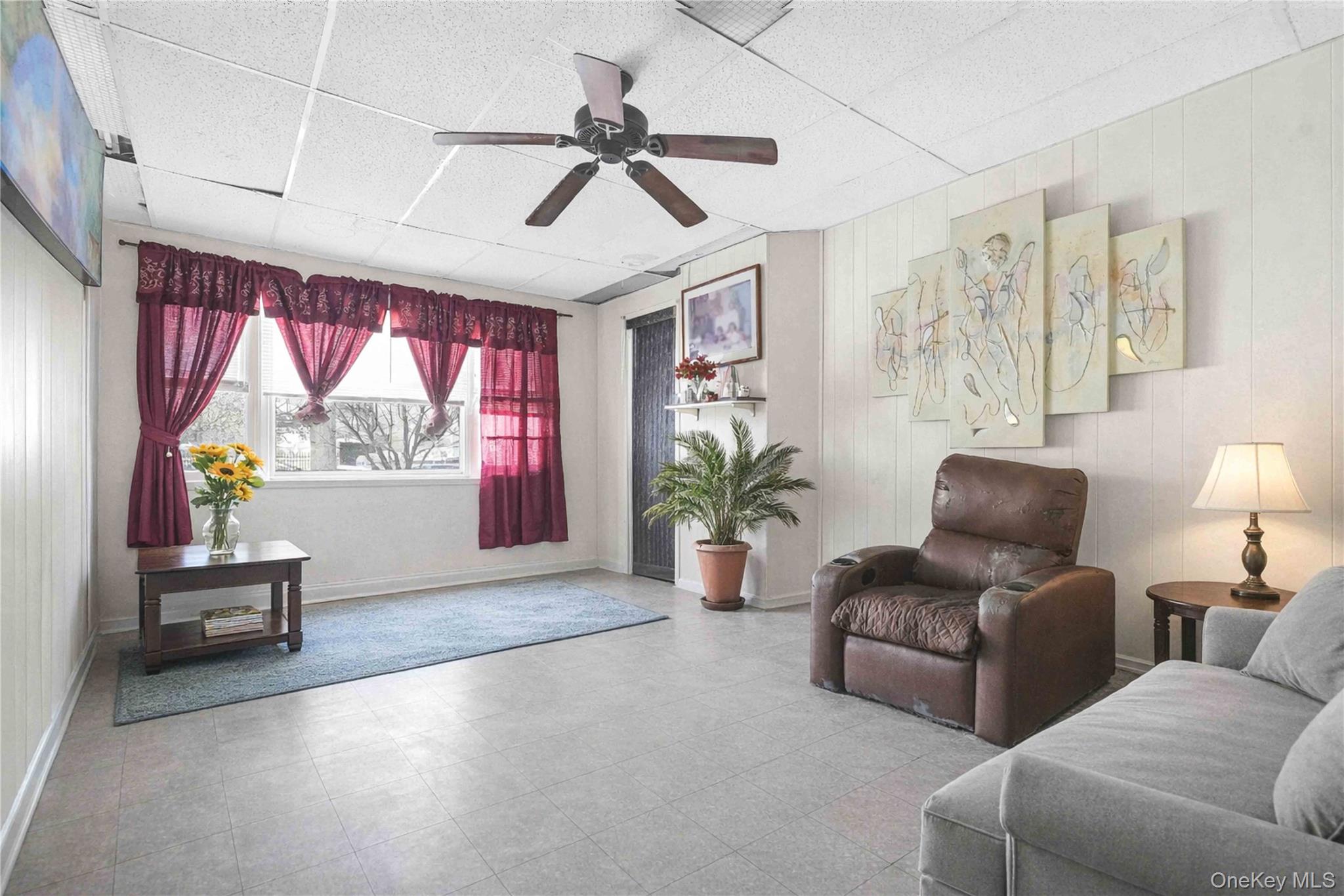 96-12 34th Avenue Queens, NY 11368 - Photo 14 of 35 a living room with furniture and a large window