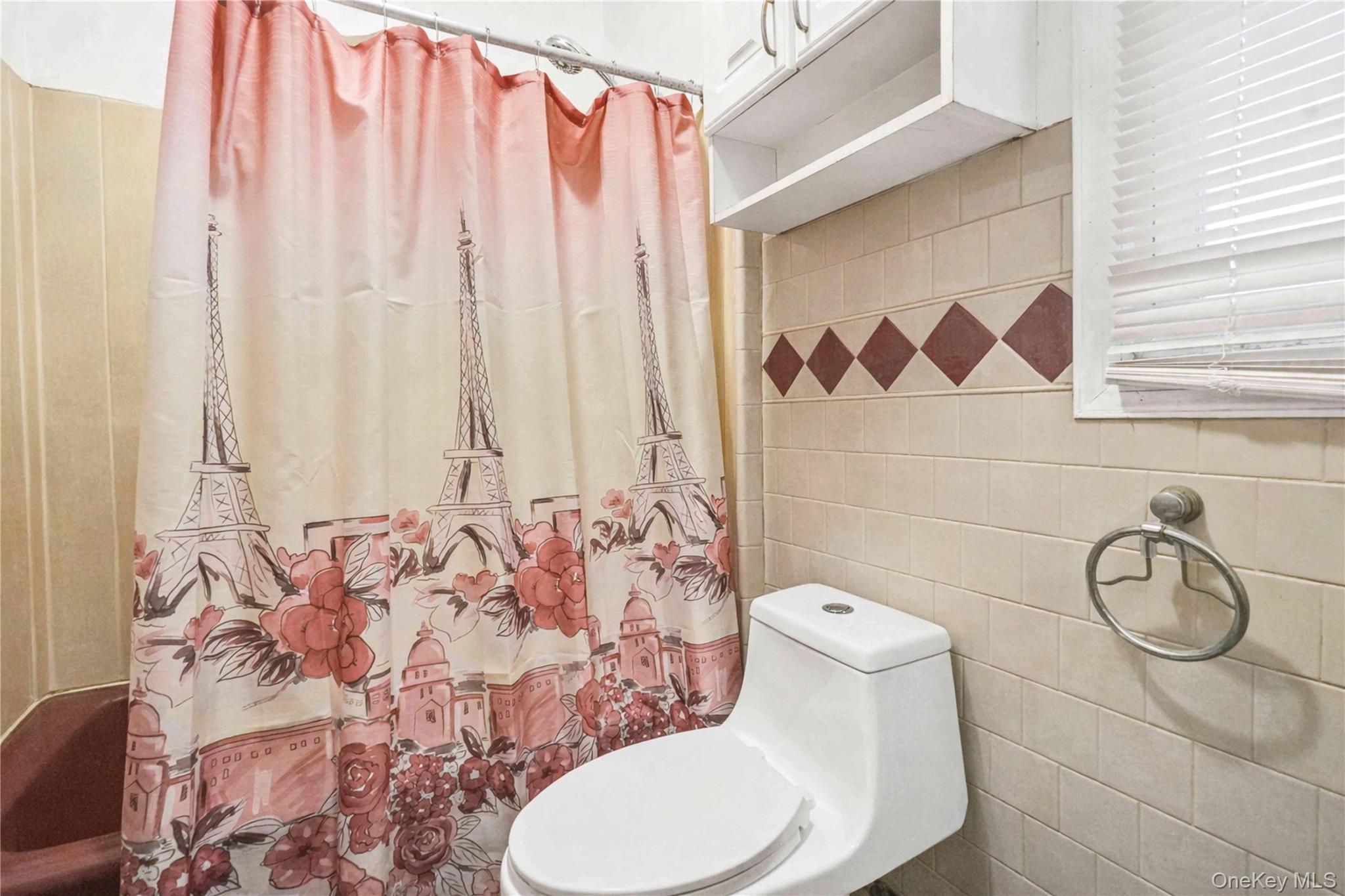 96-12 34th Avenue Queens, NY 11368 - Photo 15 of 35 a bathroom with a toilet and a shower curtain