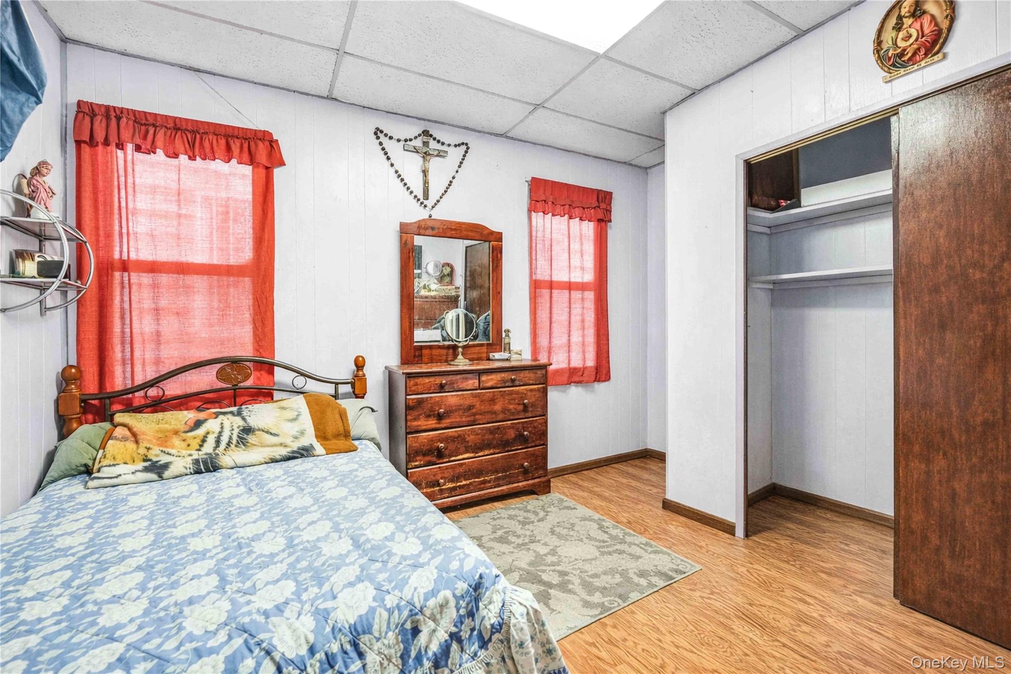 96-12 34th Avenue Queens, NY 11368 - Photo 17 of 35 a bedroom with a bed and a dresser