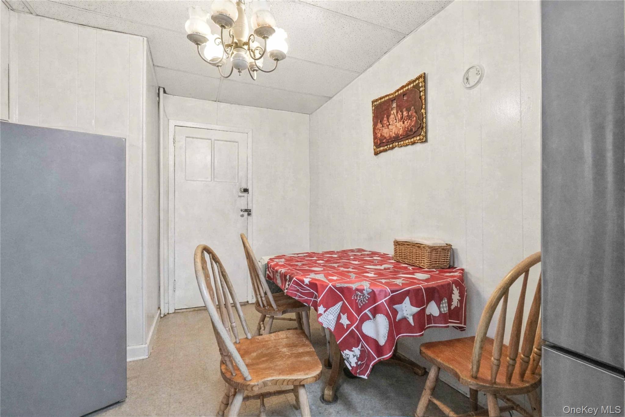 96-12 34th Avenue Queens, NY 11368 - Photo 20 of 35 a bedroom with a bed and a chandelier