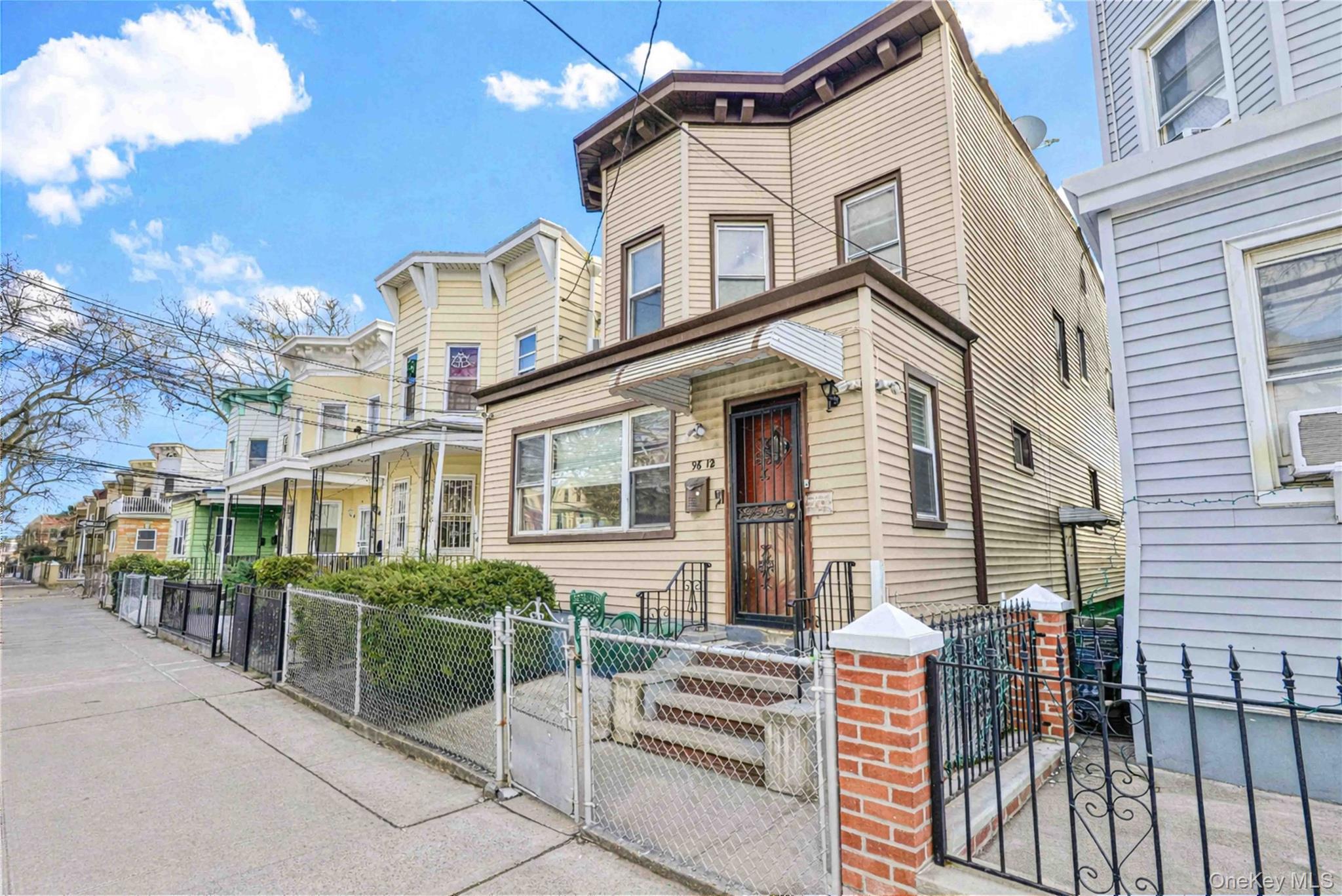 96-12 34th Avenue Queens, NY 11368 - Photo 2 of 35 a front view of a house with a garden
