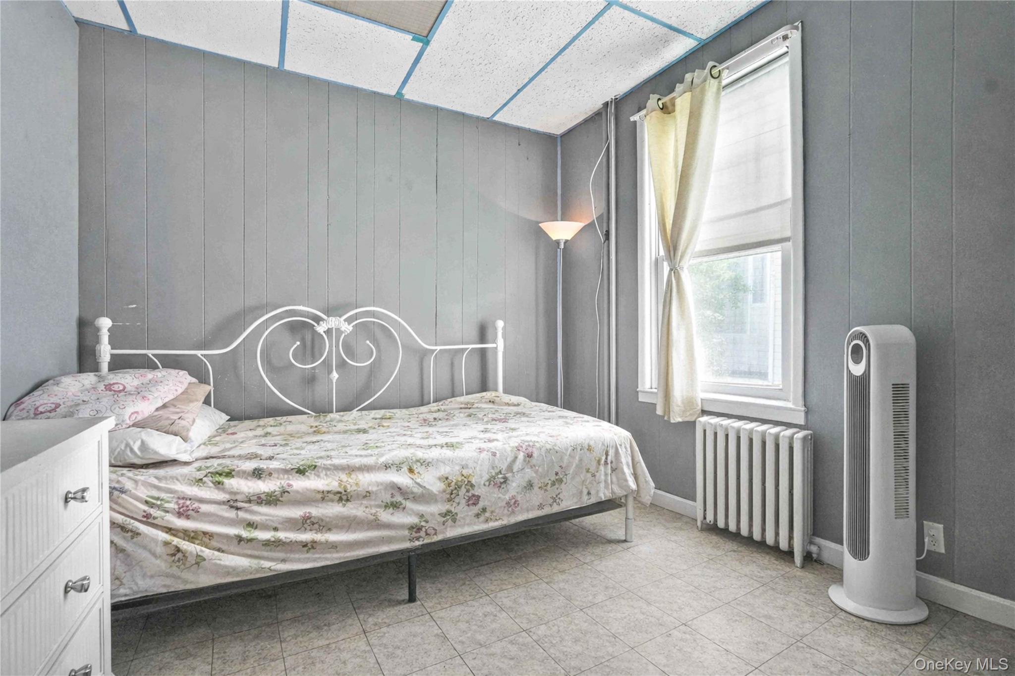 96-12 34th Avenue Queens, NY 11368 - Photo 22 of 35 a bedroom with a bed and a window