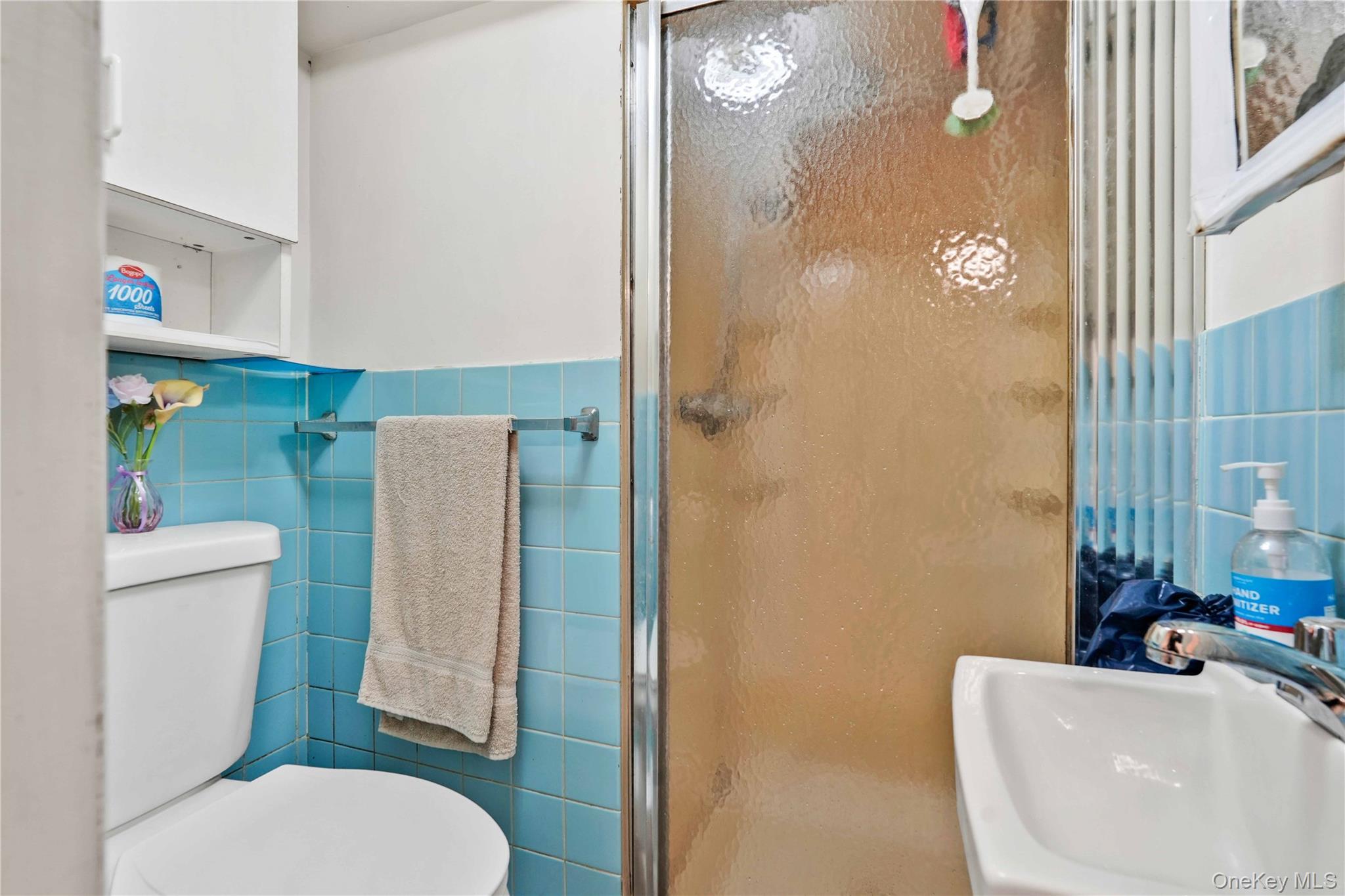 96-12 34th Avenue Queens, NY 11368 - Photo 23 of 35 a white toilet sitting next to a bathroom sink