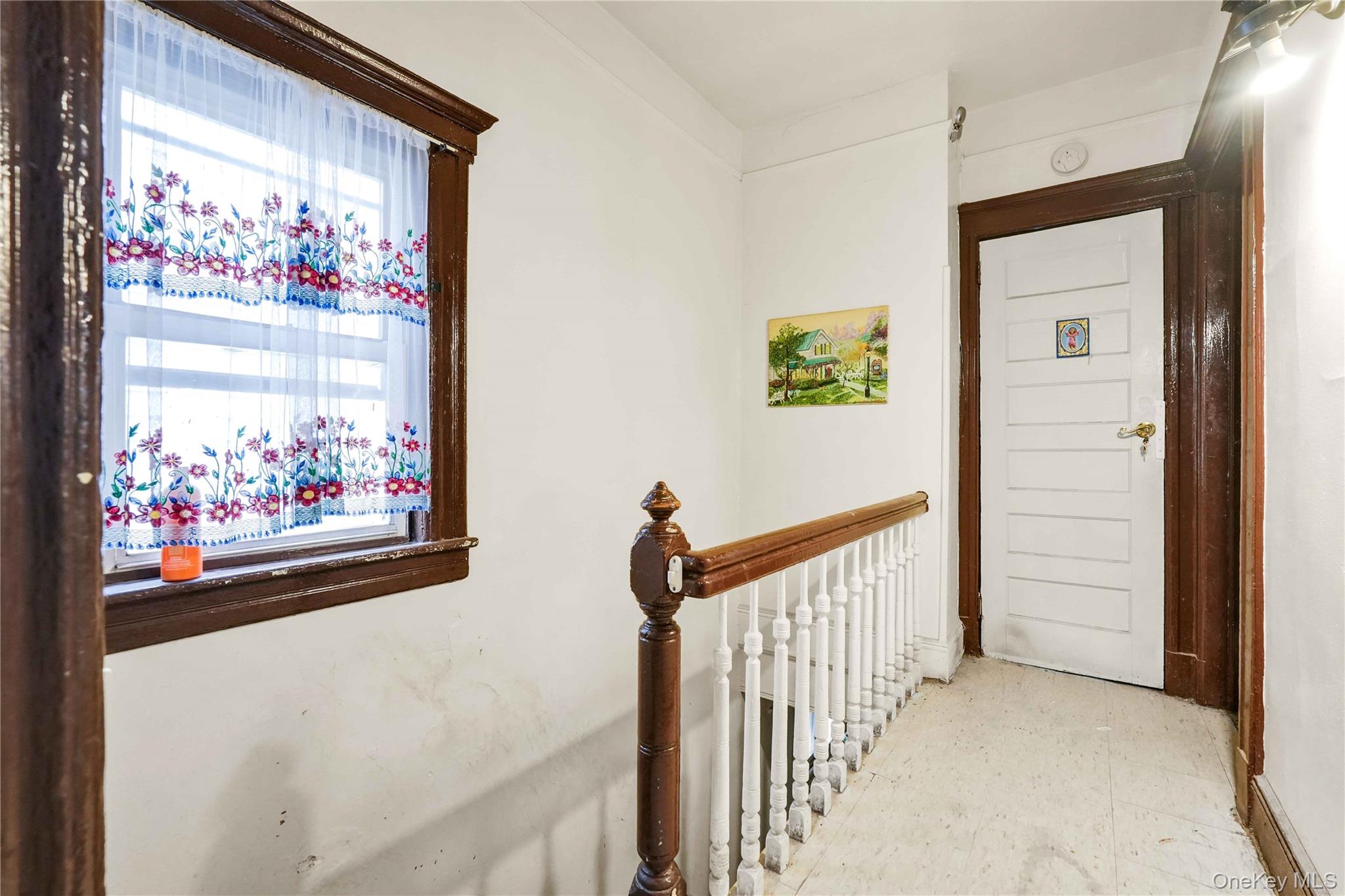 96-12 34th Avenue Queens, NY 11368 - Photo 3 of 35 a view of a hallway with a painting on the wall