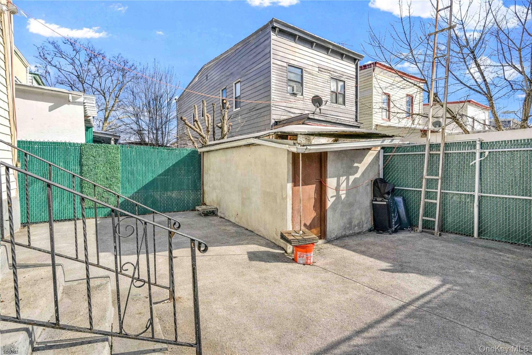96-12 34th Avenue Queens, NY 11368 - Photo 31 of 35 a front view of a house with garage
