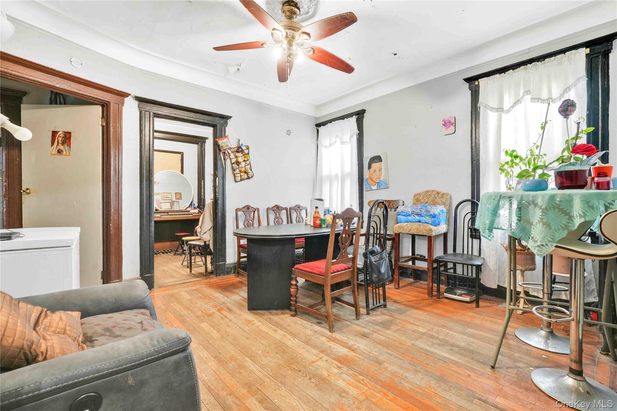 96-12 34th Avenue Queens, NY 11368 - Photo 9 of 35 a living room with furniture and a large window