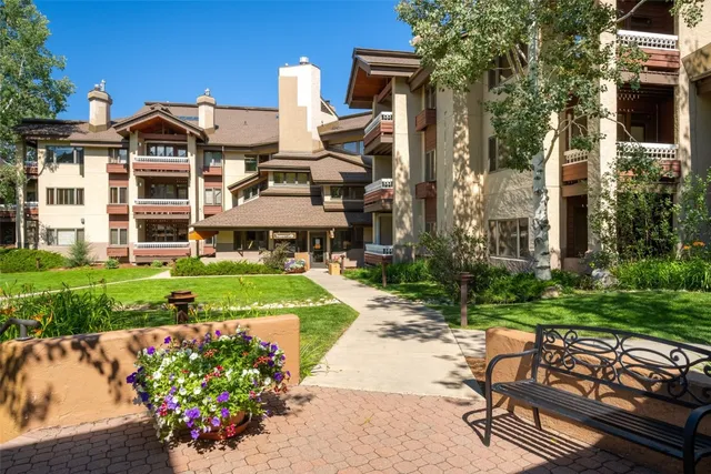 a front view of a house with a garden and porch