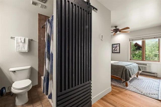 a bathroom with a toilet a sink and a mirror