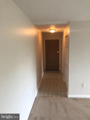 a view of an empty room with a fireplace