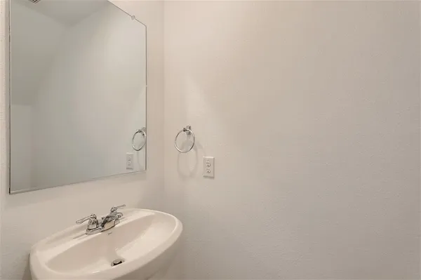 an empty room with a window and a ceiling fan