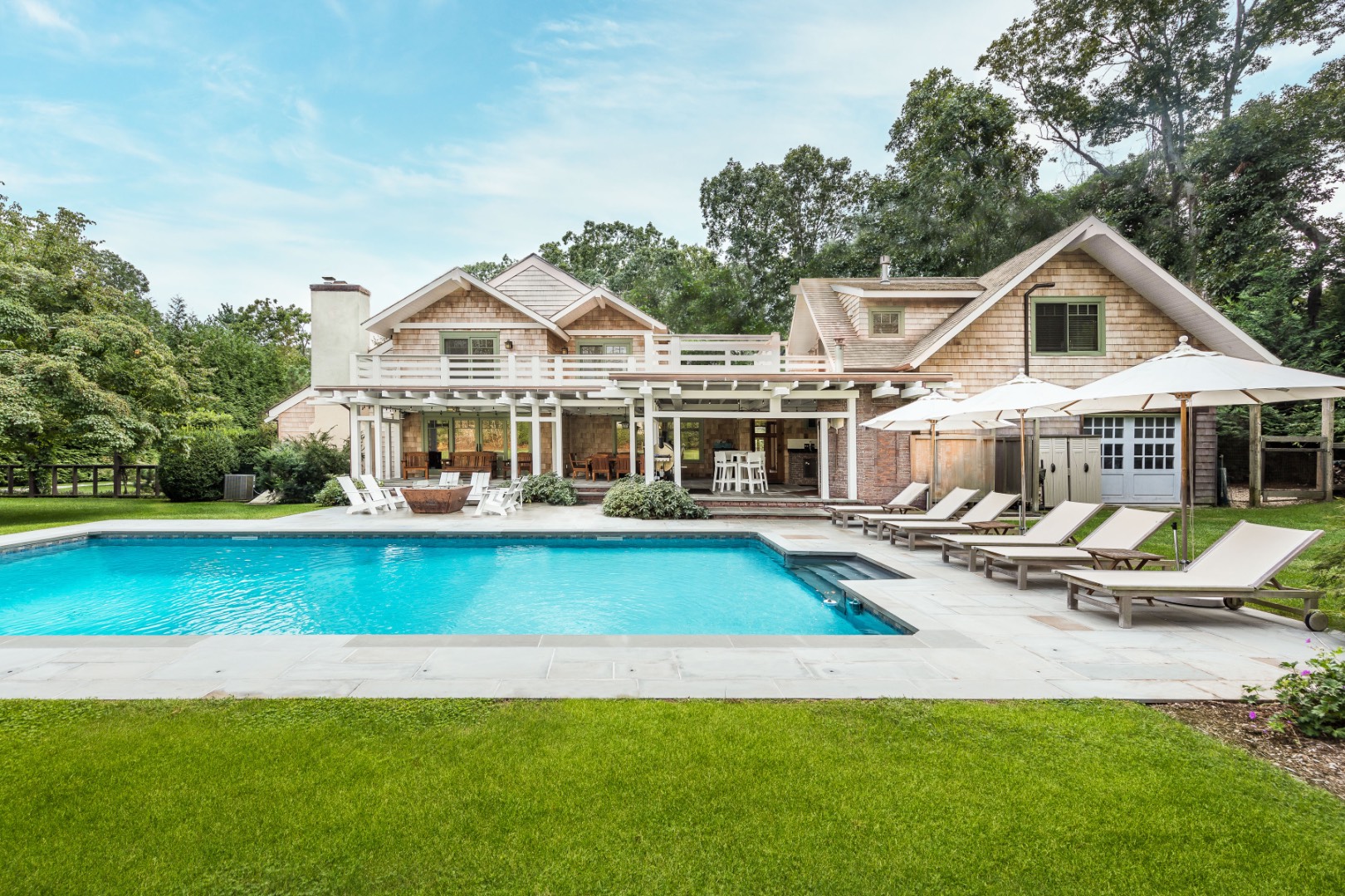 30 East Hollow Road East Hampton, NY 11937 - Photo 1 of 29 a front view of a house with swimming pool having outdoor seating