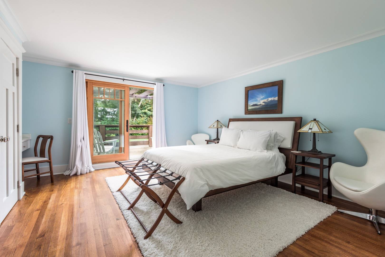30 East Hollow Road East Hampton, NY 11937 - Photo 20 of 29 a bedroom with a bed a table and chair