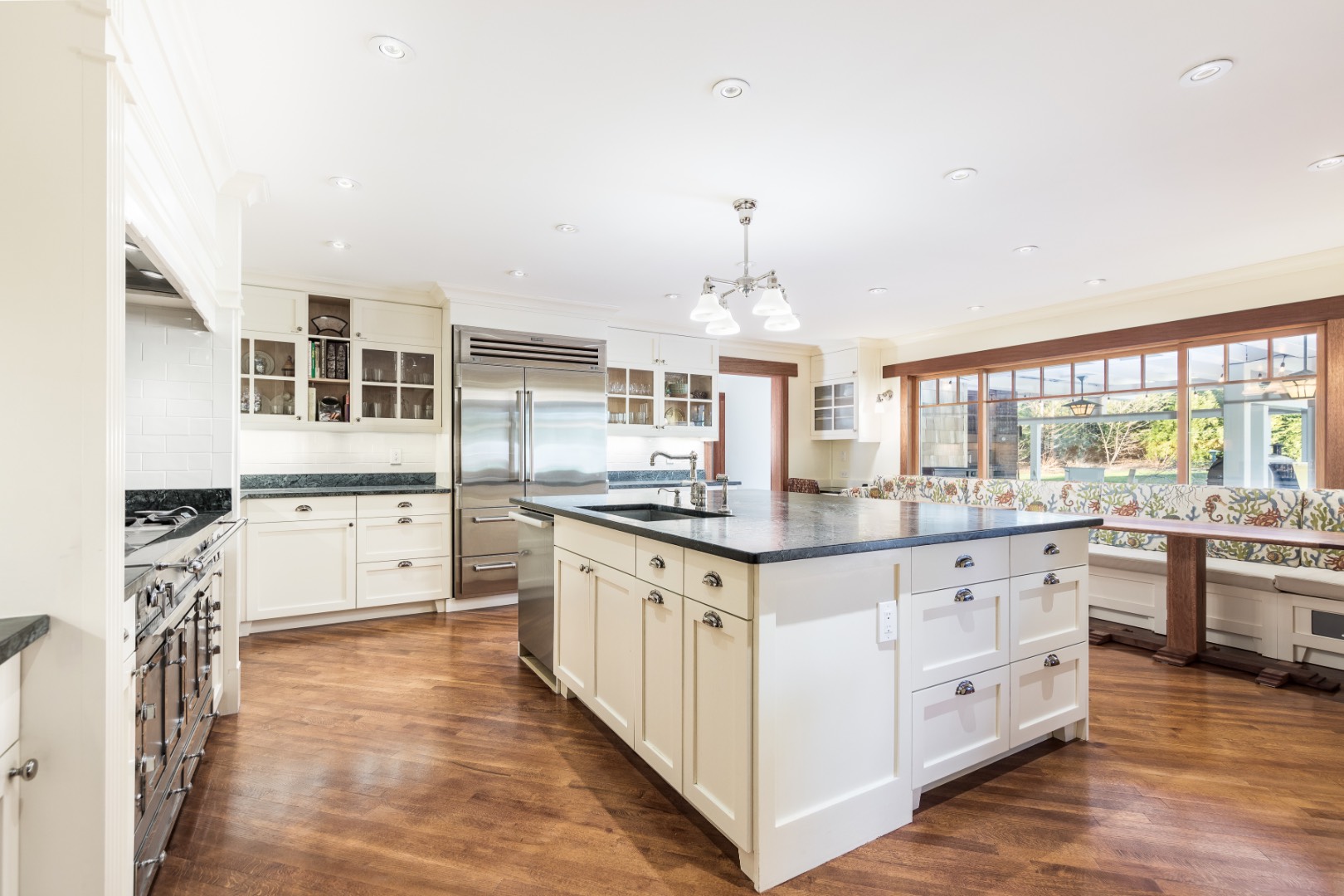 30 East Hollow Road East Hampton, NY 11937 - Photo 7 of 29 a large kitchen with cabinets and wooden floor