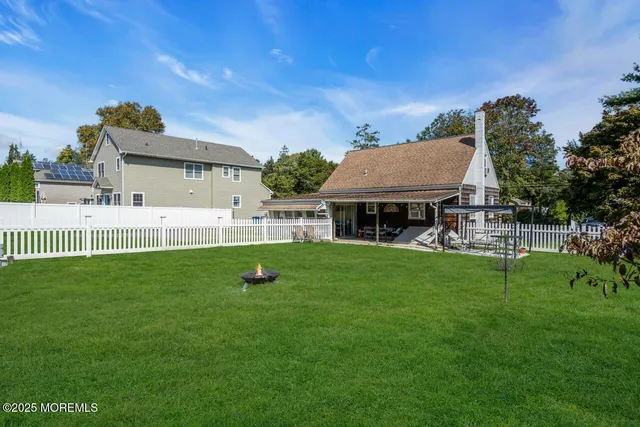 a view of a house with a backyard