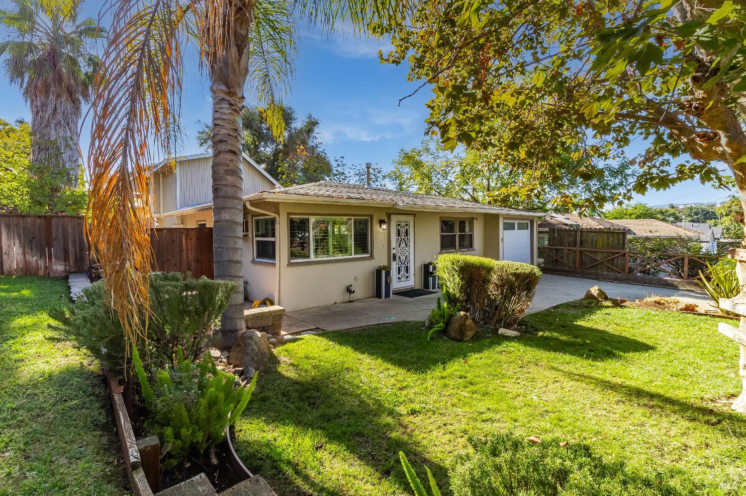 a view of a house with backyard sitting area and garden