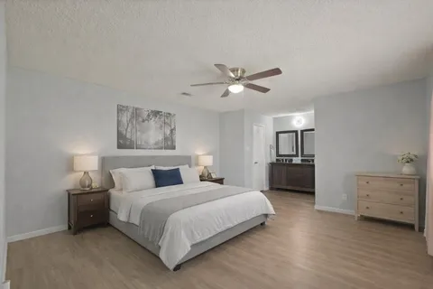 a bedroom with a bed and a chandelier