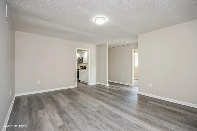 a view of an empty room and wooden floor
