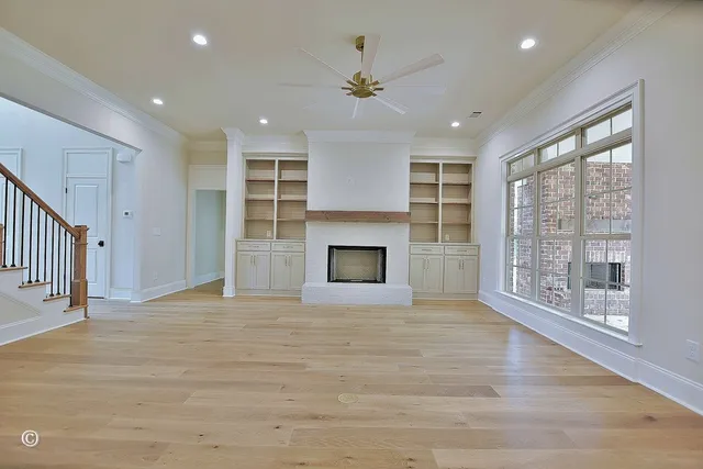 a view of an empty room with a fireplace and a window