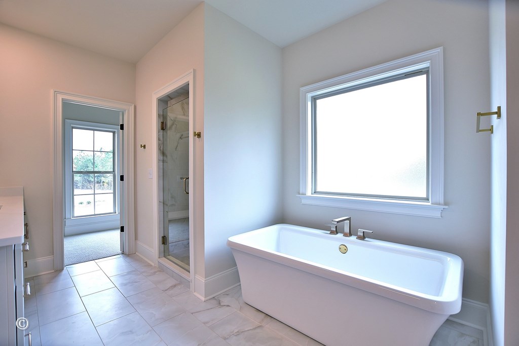 5905 Linley Court Midland, GA 31820 - Photo 19 of 41 a white bath tub sitting in a bathroom next to a window