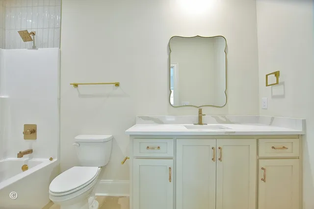a utility room with a sink a vanity and mirror