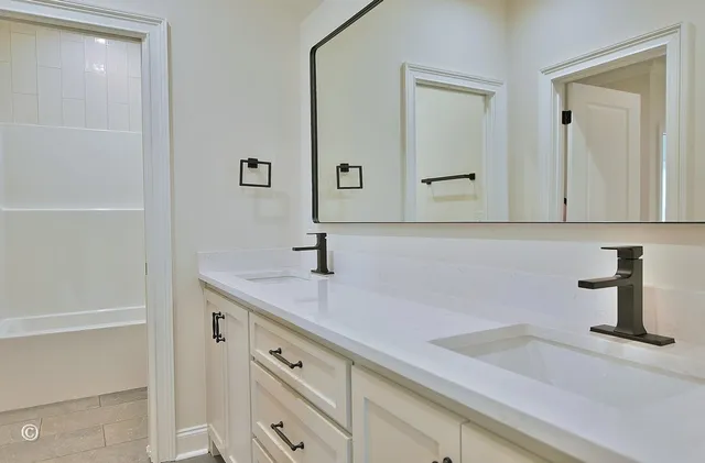 an empty room with windows and ceiling fan