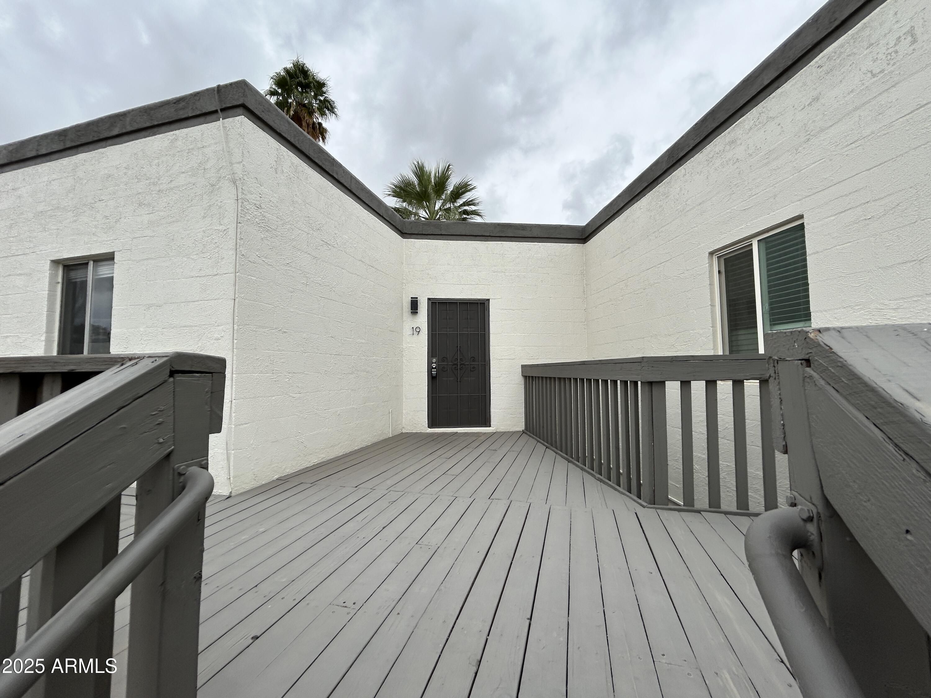 6236 North 16th Street, Unit 19 Phoenix, AZ 85016 - Photo 1 of 18 a view of balcony with wooden floor