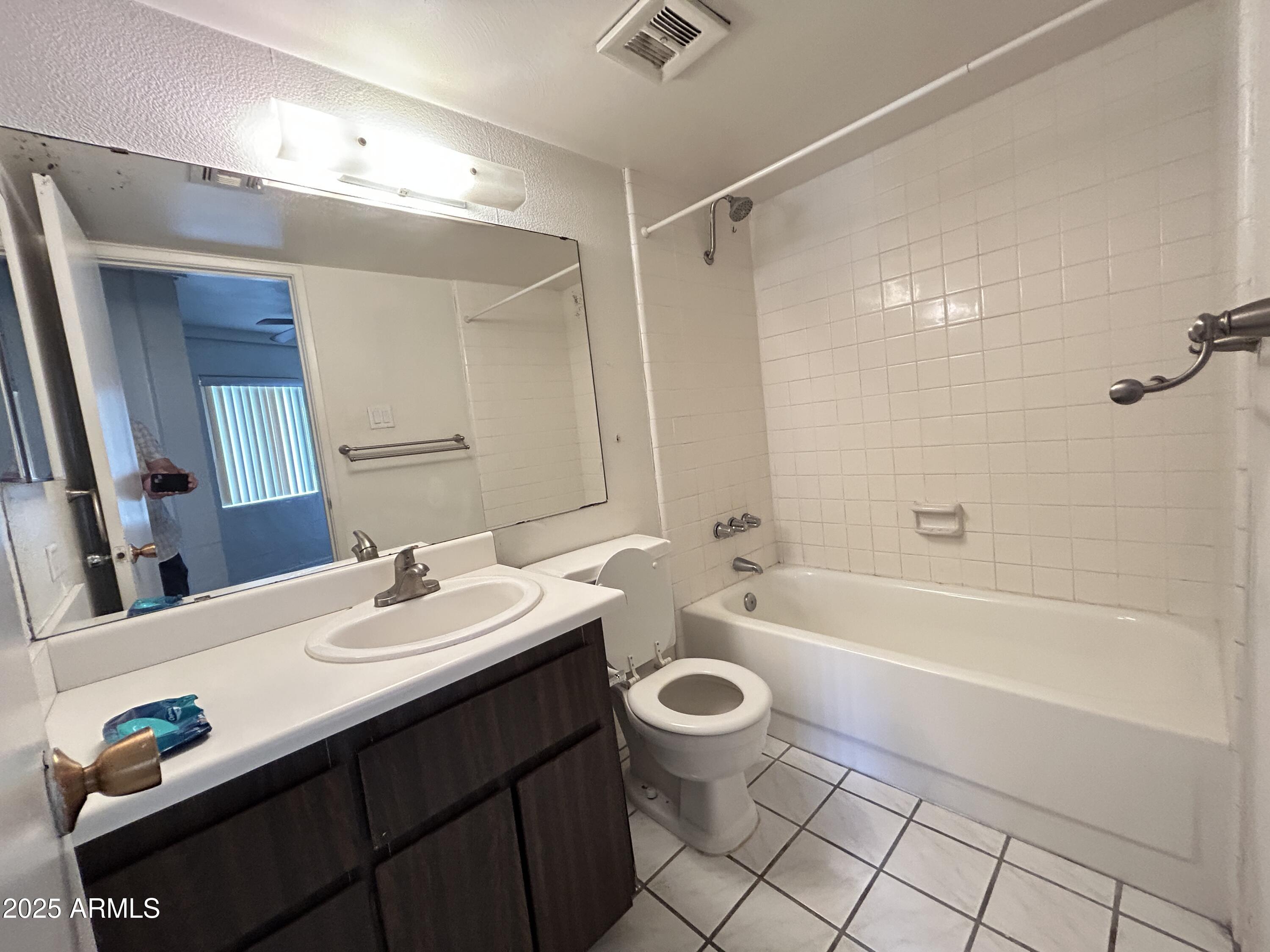 6236 North 16th Street, Unit 19 Phoenix, AZ 85016 - Photo 15 of 18 a bathroom with a sink a toilet a mirror a bathtub and shower