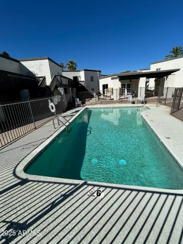 a backyard of a house with table and chairs