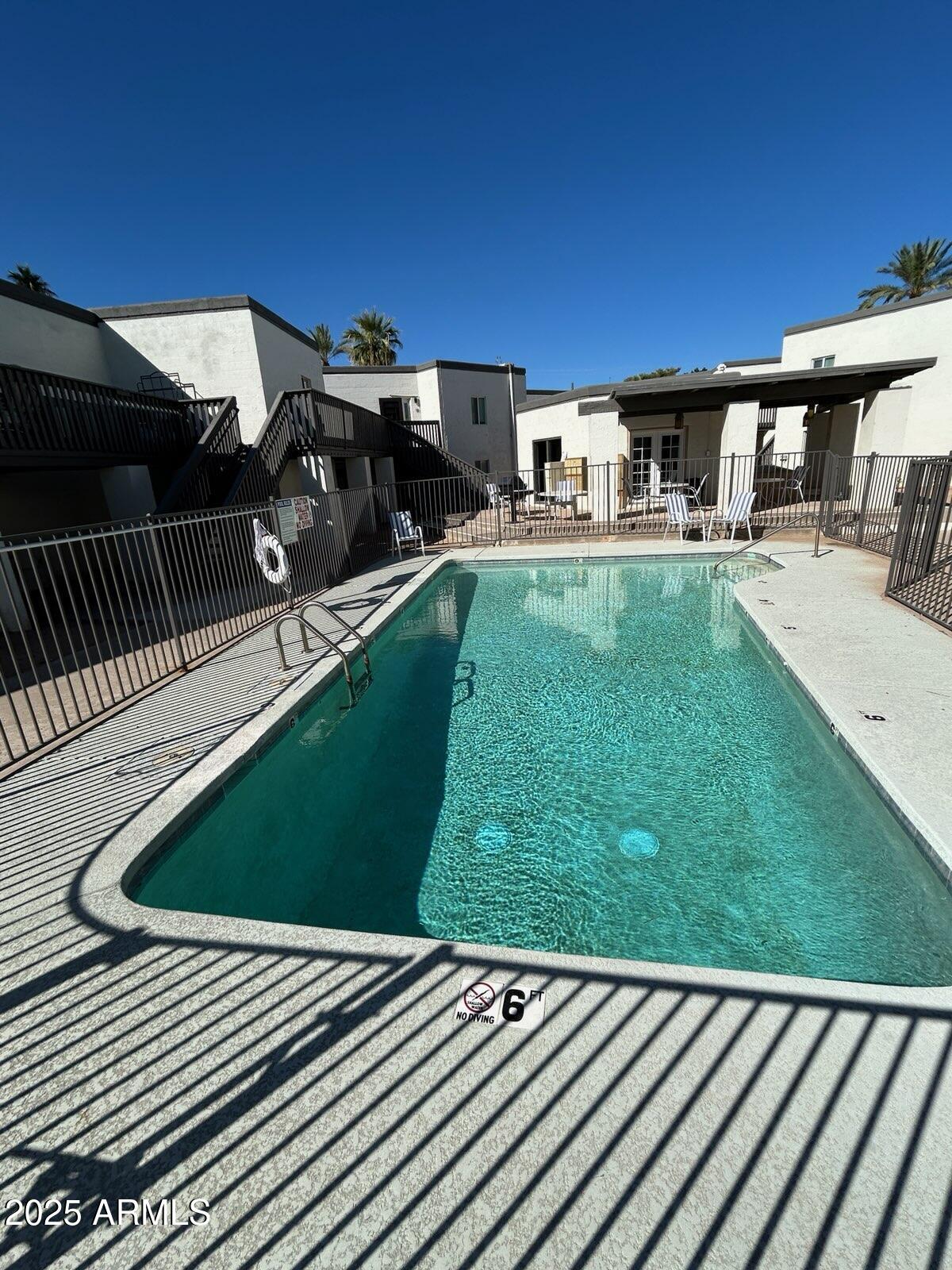 6236 North 16th Street, Unit 19 Phoenix, AZ 85016 - Photo 17 of 18 a backyard of a house with table and chairs