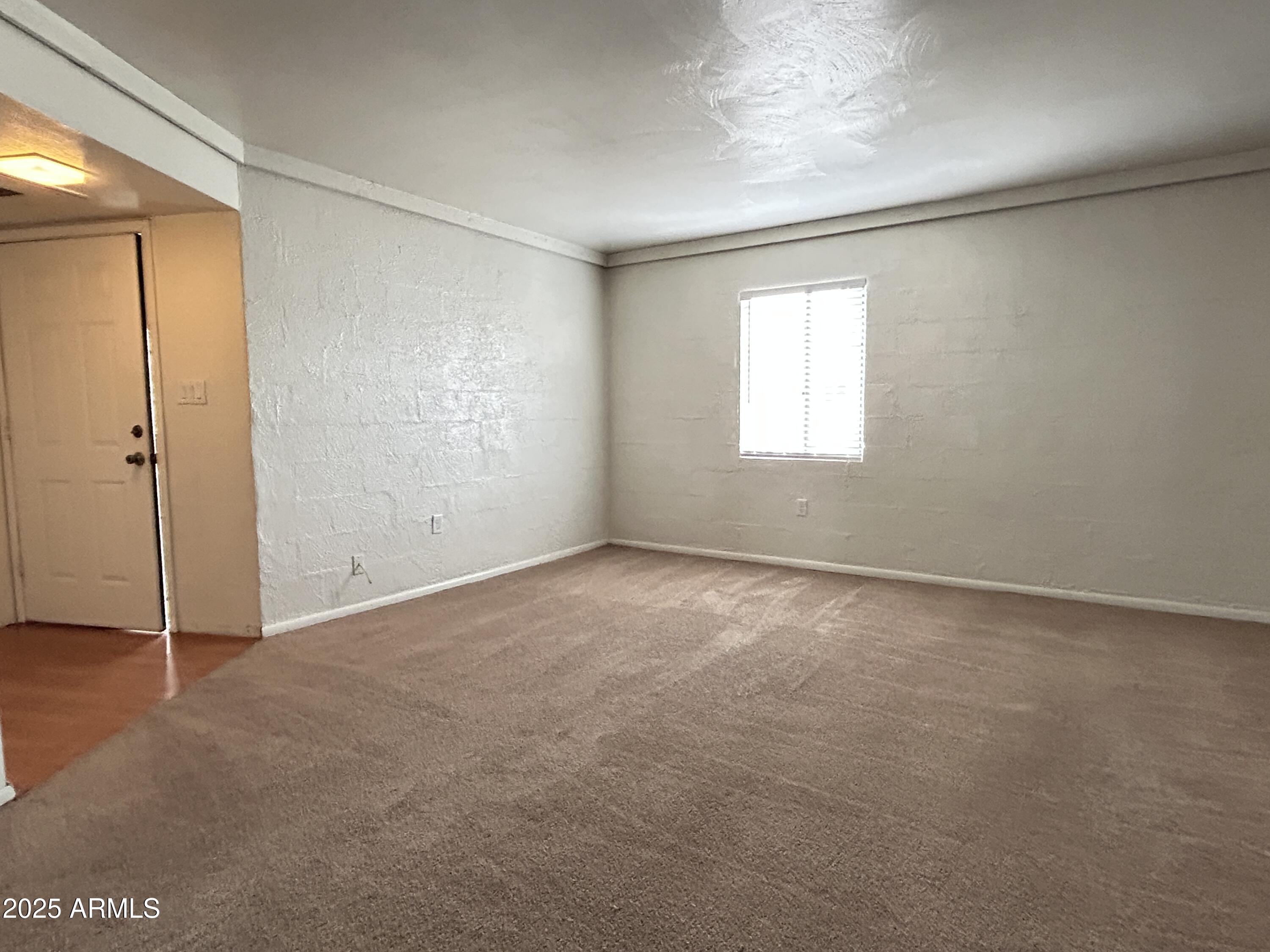 6236 North 16th Street, Unit 19 Phoenix, AZ 85016 - Photo 5 of 18 an empty room with windows and closet