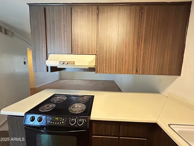 a stove top oven sitting inside of a kitchen