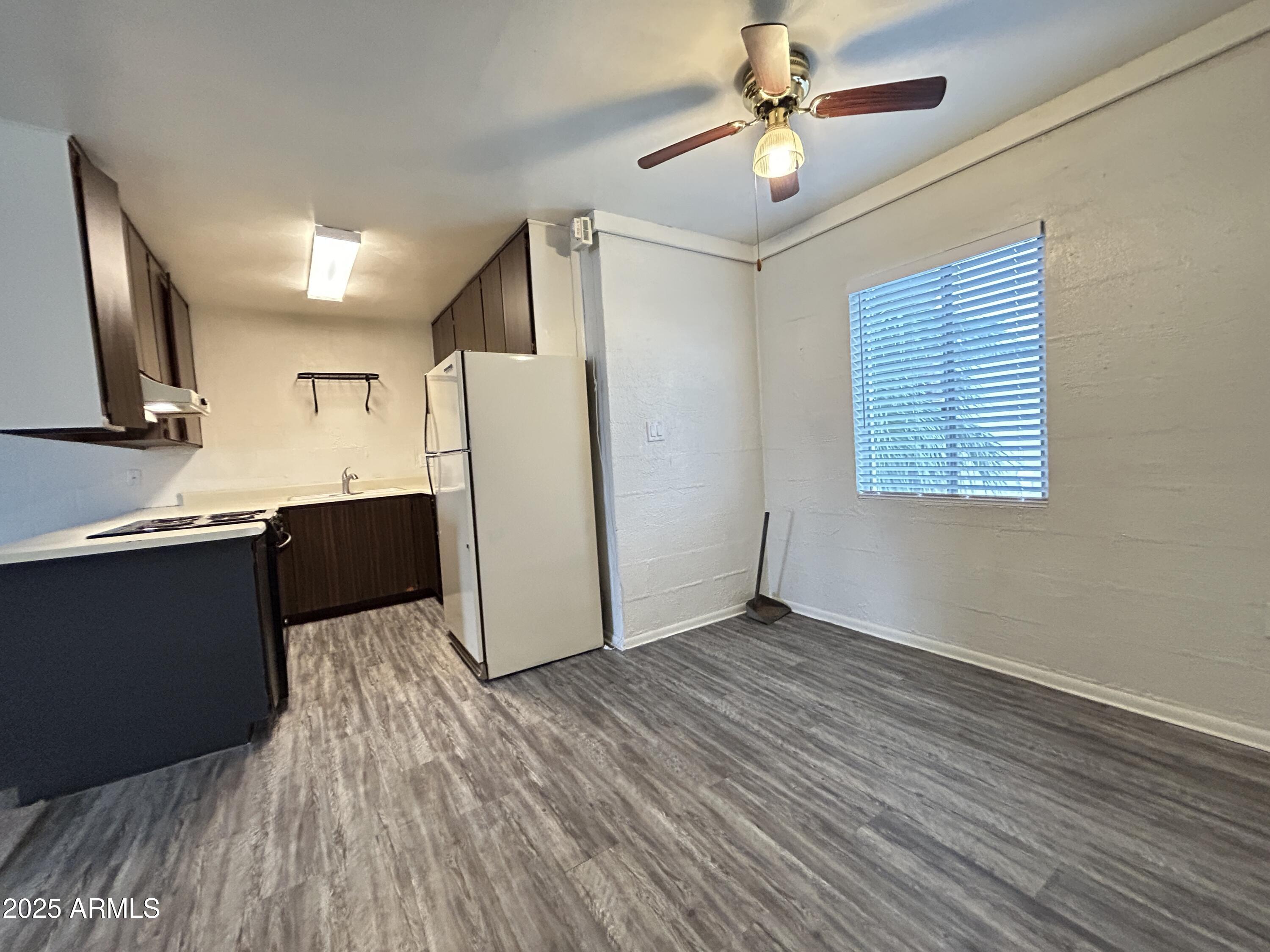 6236 North 16th Street, Unit 19 Phoenix, AZ 85016 - Photo 8 of 18 a kitchen with granite countertop a refrigerator and a stove top oven