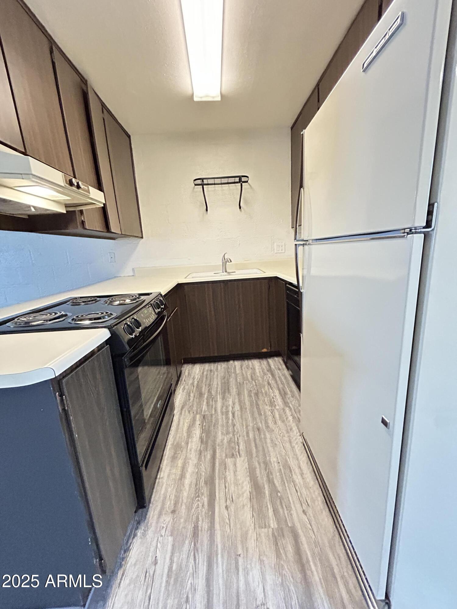 6236 North 16th Street, Unit 19 Phoenix, AZ 85016 - Photo 9 of 18 a kitchen with a sink and wooden floor