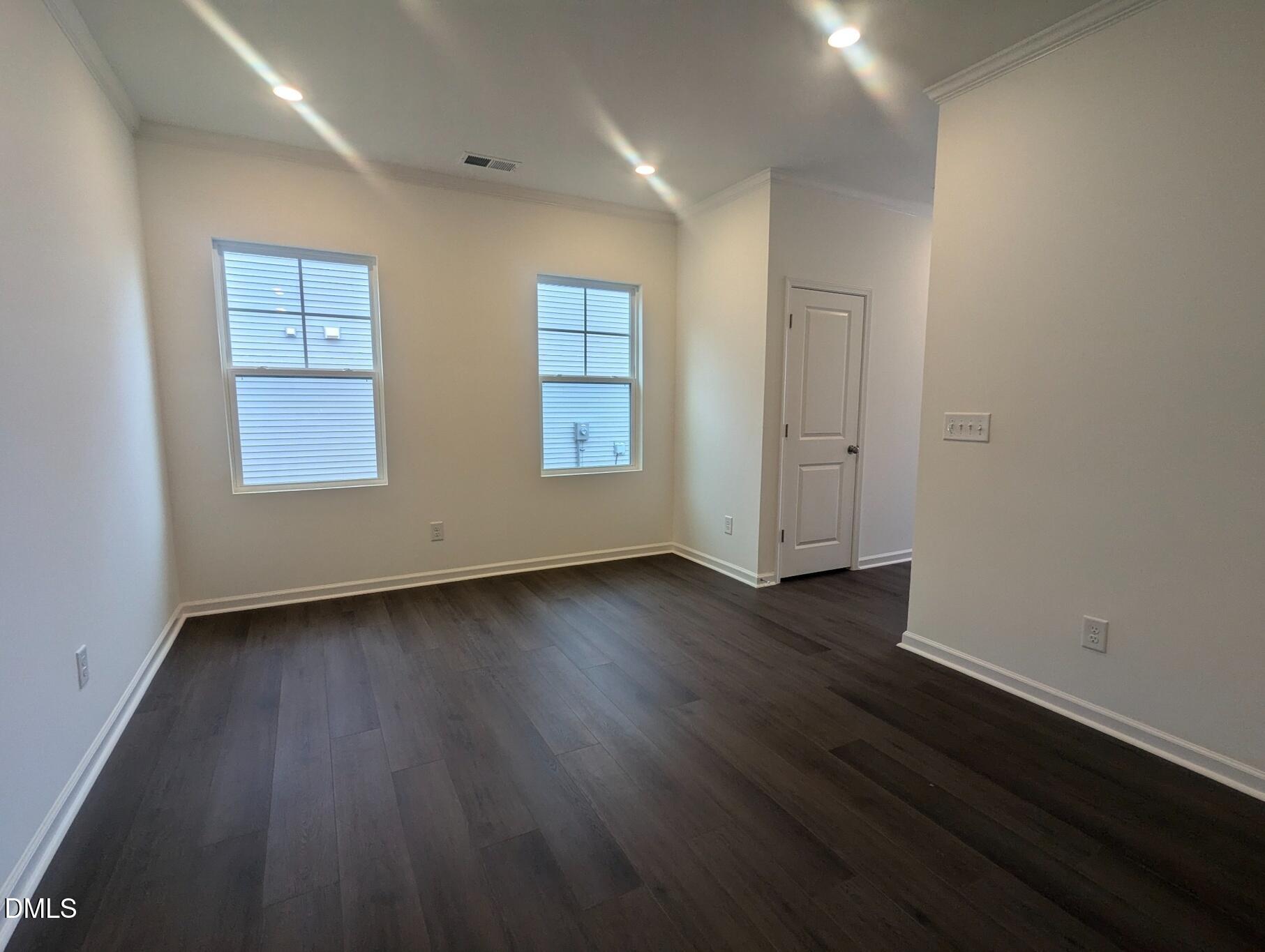 1000 Red Finch Way Angier, NC 27501 - Photo 3 of 31 an empty room with wooden floor and windows