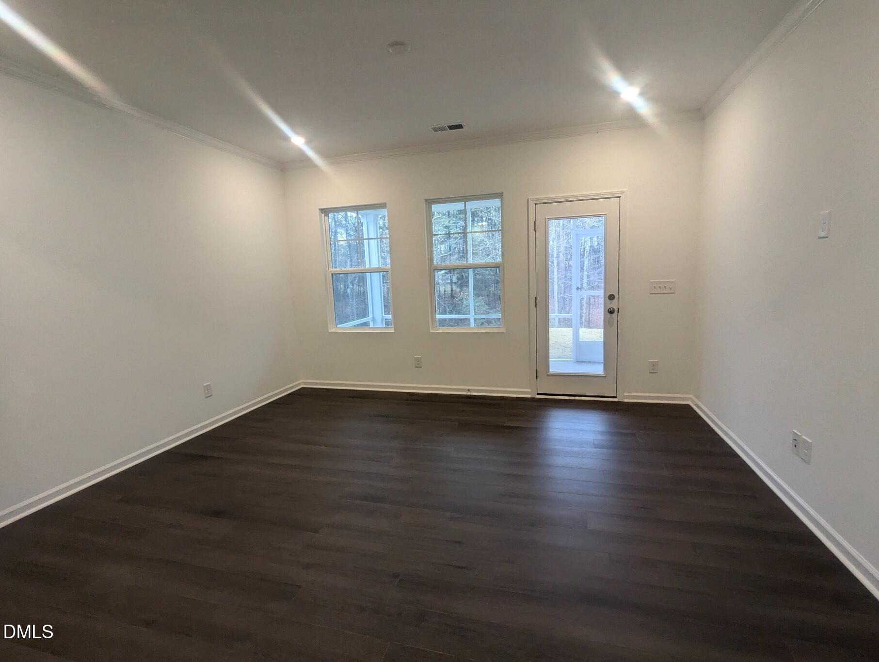 1000 Red Finch Way Angier, NC 27501 - Photo 4 of 31 an empty room with wooden floor and windows