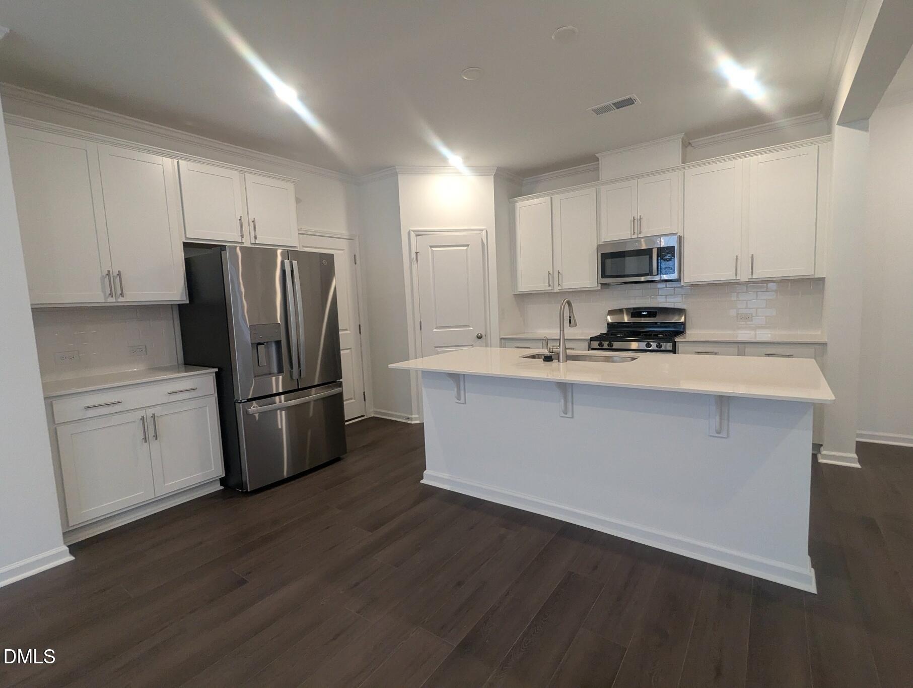1000 Red Finch Way Angier, NC 27501 - Photo 7 of 31 a kitchen with stainless steel appliances a refrigerator sink and microwave