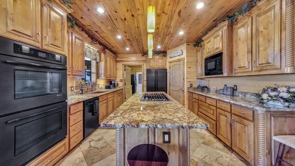 a bathroom with a granite countertop sink a mirror and a bathtub