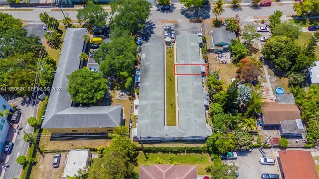 an aerial view of a house with a yard and garden