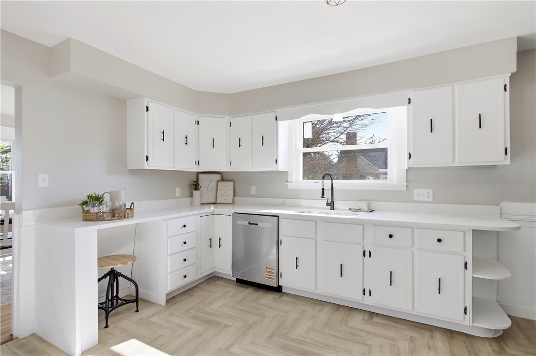 1925 Sunset Avenue Springfield, OH 45505 - Photo 19 of 45 This bright kitchen features white cabinetry and modern appliances, creating a welcoming and functional space.
